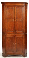 Lot 1173 - A Georgian oak standing corner cupboard, the...