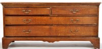 Lot 1174 - A George III oak chest of two short and two...