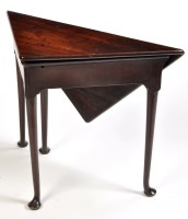 Lot 1242 - A George III mahogany drop leaf corner table,...