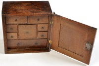 Lot 1251 - An 18th Century oak spice cabinet, the panel...