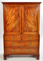 Lot 1335 - A George III mahogany linen press, the flared...