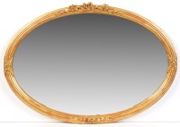 Lot 1344 - A 19th Century oval wall mirror, the plate in...