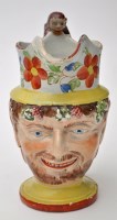 Lot 730 - Painted pearlware character jug of Bacchus,...