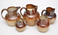 Lot 749 - Five salt glaze stoneware jugs, with applied...