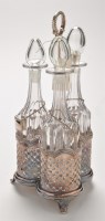 Lot 808 - An early 20th Century three bottle decanter...