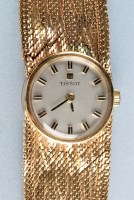 Lot 938 - Tissot: a 9ct. gold lady's wristwatch, with...