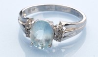 Lot 947 - An aquamarine and diamond ring, the oval facet-...