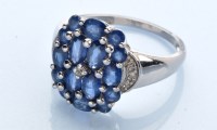 Lot 948 - A sapphire and diamond ring, the oval and...