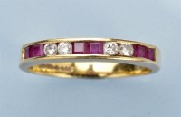 Lot 955 - A ruby and diamond half-hoop eternity ring,...