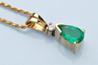 Lot 956 - An emerald and diamond pendant, the pear-cut...