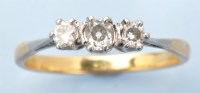 Lot 958 - A three stone diamond ring, the three...