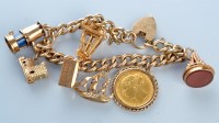 Lot 959 - A 9ct yellow gold charm bracelet, of curb link...