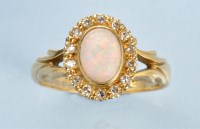 Lot 969 - An opal and diamond cluster ring, the white...