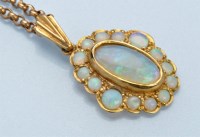 Lot 970 - An opal cluster pendant, the central oval...