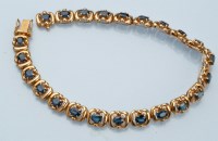 Lot 973 - A sapphire and yellow metal bracelet, each of...