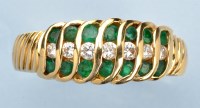 Lot 975 - An emerald and diamond ring, set with seven...