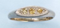 Lot 978 - A three stone yellow diamond ring, the three...