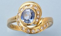 Lot 986 - A sapphire and diamond ring, the oval...