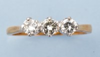 Lot 989 - A three stone diamond ring, the brilliant-cut...