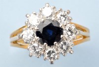 Lot 990 - A sapphire and diamond cluster ring, the...