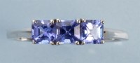 Lot 1000 - A three stone tanzanite ring, the three...