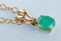 Lot 1002 - An emerald pendant, the oval facet-cut emerald...