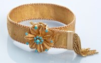 Lot 1009 - A yellow metal mesh bracelet, decorated with...