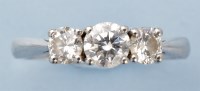 Lot 1011 - A three stone diamond ring, the graduated...