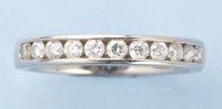 Lot 1012 - A diamond half-hoop eternity ring, channel set...