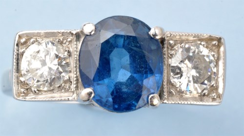 Lot 1015 - A sapphire and diamond ring, the oval...
