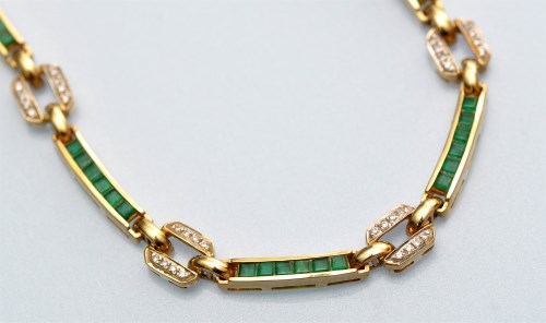 Lot 1017 - An emerald and diamond necklace, each oblong...