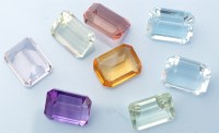 Lot 1019 - Loose emerald-cut gemstones, to include: a...