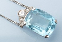 Lot 1021 - An aquamarine and diamond pendant, the oval...