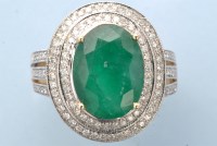 Lot 1023 - An emerald and diamond ring, the oval faceted...