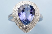 Lot 1024 - A tanzanite and diamond cluster ring, the pear-...