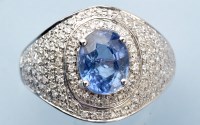 Lot 1025 - A sapphire and diamond ring, the oval...