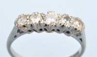 Lot 1027 - A five stone diamond ring, the graduated...