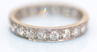 Lot 1035 - A diamond eternity ring, set throughout with...