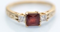 Lot 1036 - A garnet and diamond ring, the French cut...