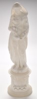 Lot 1201 - A carved white marble female figure garlanded...