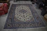 Lot 1224 - A Kashan carpet, the blue floral scrolls on...