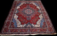 Lot 1228 - A Heriz carpet, red ground decorated with...