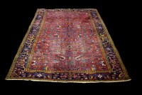 Lot 1230 - A Heriz carpet, the red ground decorated with...