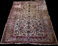 Lot 1239 - A Kashan rug, the ivory field full with floral...
