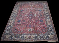 Lot 1249 - A Tabriz carpet, the claret ground with...