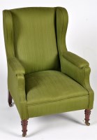 Lot 1331 - An early 20th Century wing back armchair,...