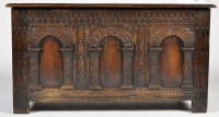 Lot 1339 - An 18th Century oak coffer, with carved arched...