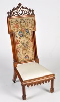 Lot 1344 - A Victorian walnut prie dieu, the high back...