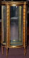 Lot 1395 - A gilt mirror back display cabinet, decorated...