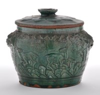 Lot 475 - Green glaze moulded pottery jar and cover, the...
